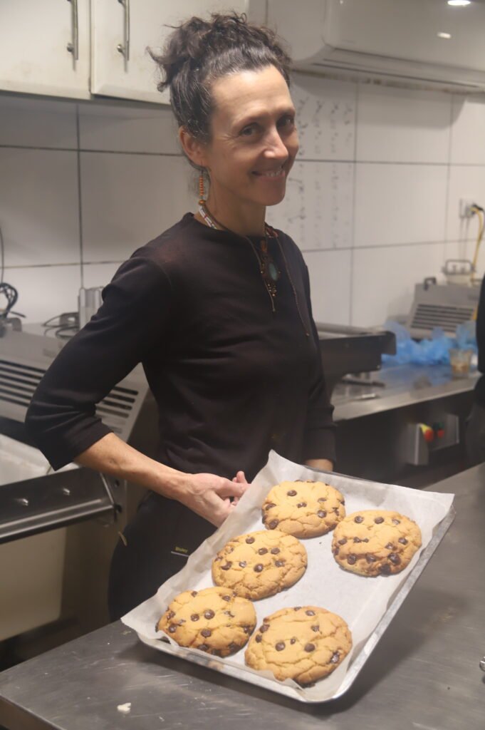 Picture of Angie, owner of Funky Pies, with a tray of the famous Giant Cookies vegan